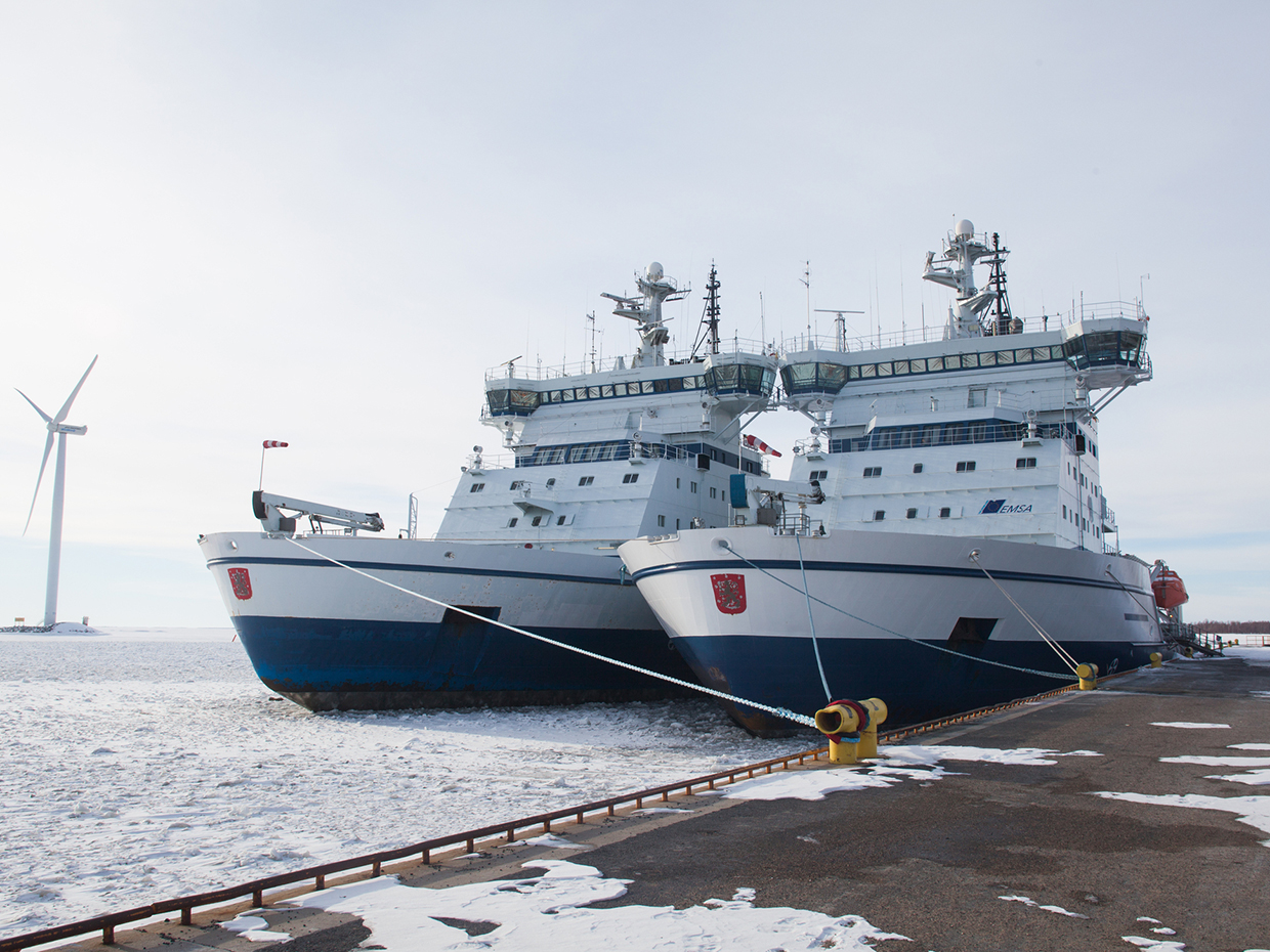 Ships in the harbour surrounded by sea ice.